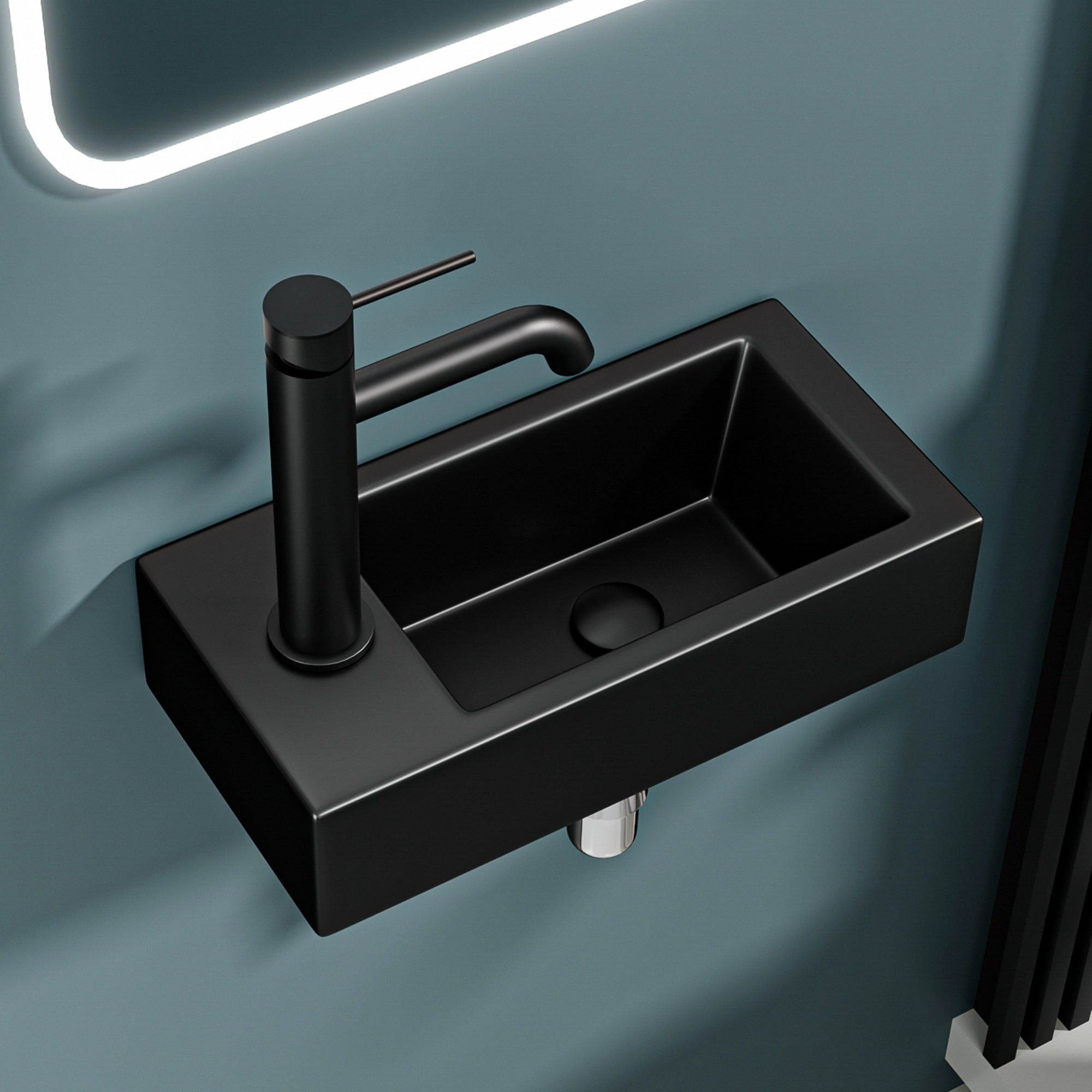 Lavabo mural noir mat avec bonde à gauche et robinet moderne