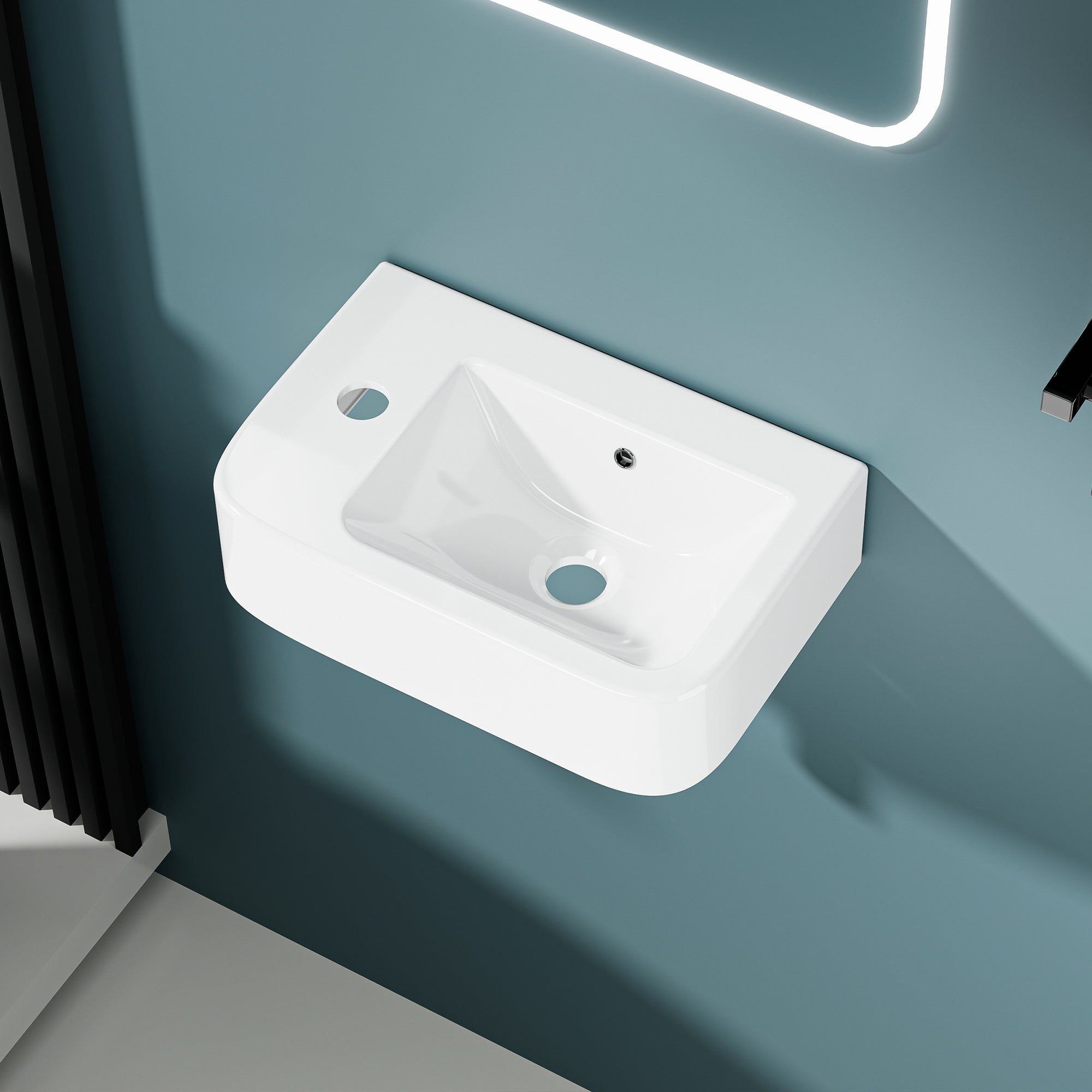 Lave-mains murale compacte en céramique blanche avec sortie de vidange gauche.