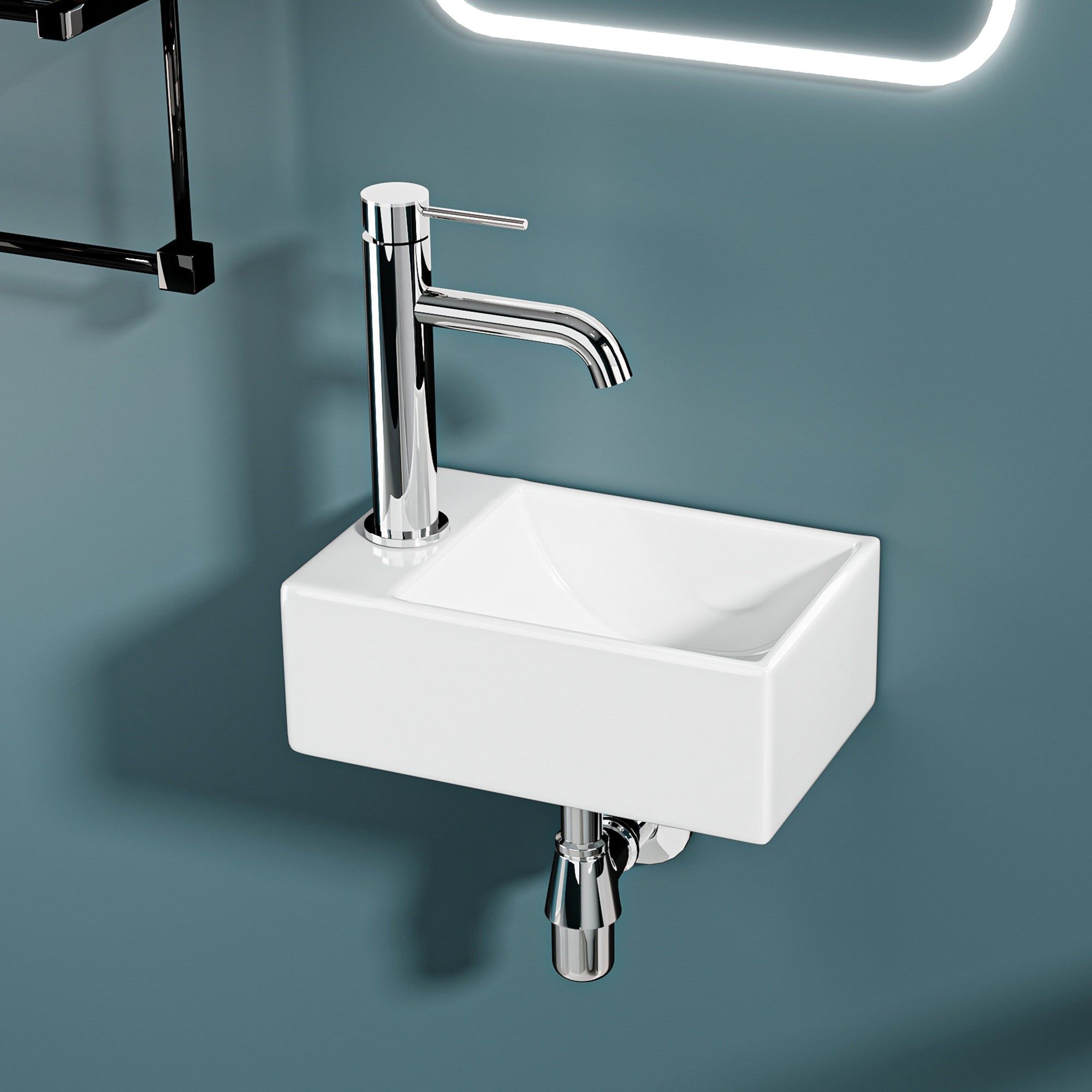 Mini lavabo mural : Lavabo compact en céramique blanche avec robinet chromé, parfait pour les petits espaces.