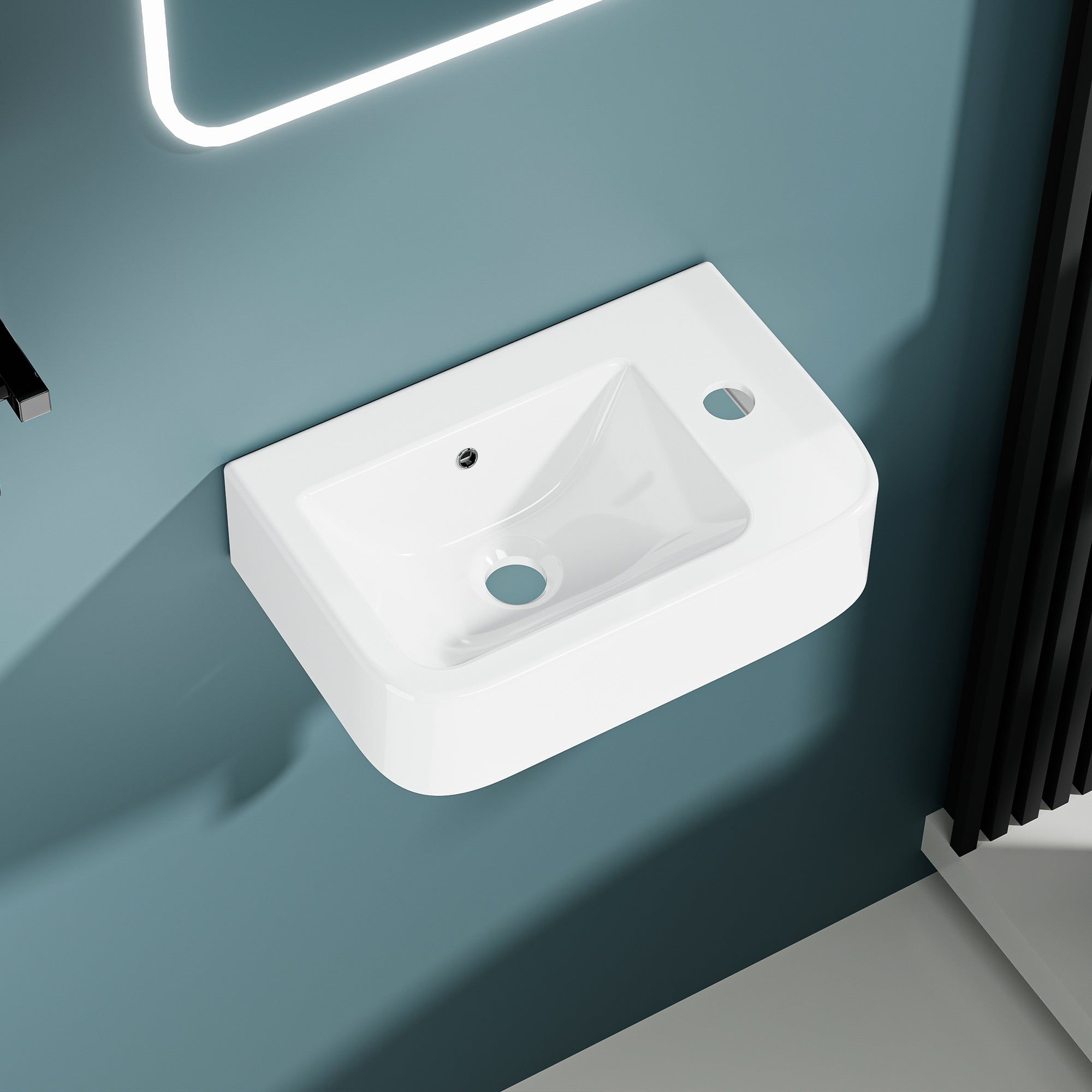 Lavabo mural compact blanc en céramique avec évacuation droite.