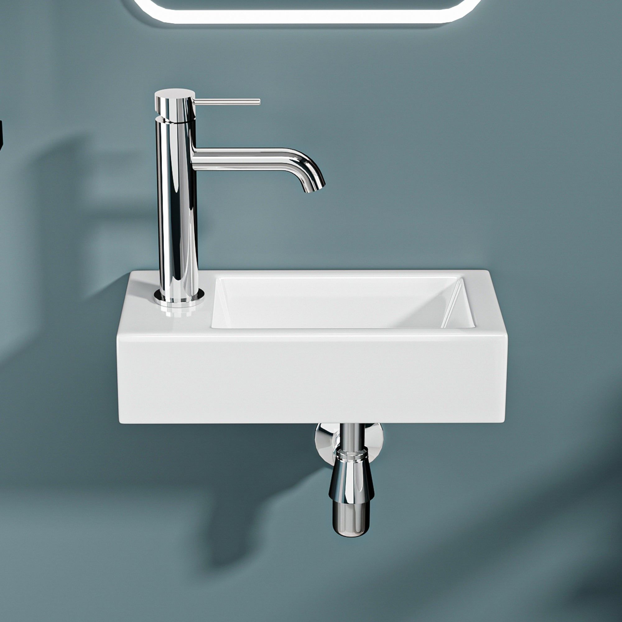 Vasque lave-mains sortie gauche : Lavabo mural compact blanc avec robinet chromé, idéal pour les petites salles de bain.