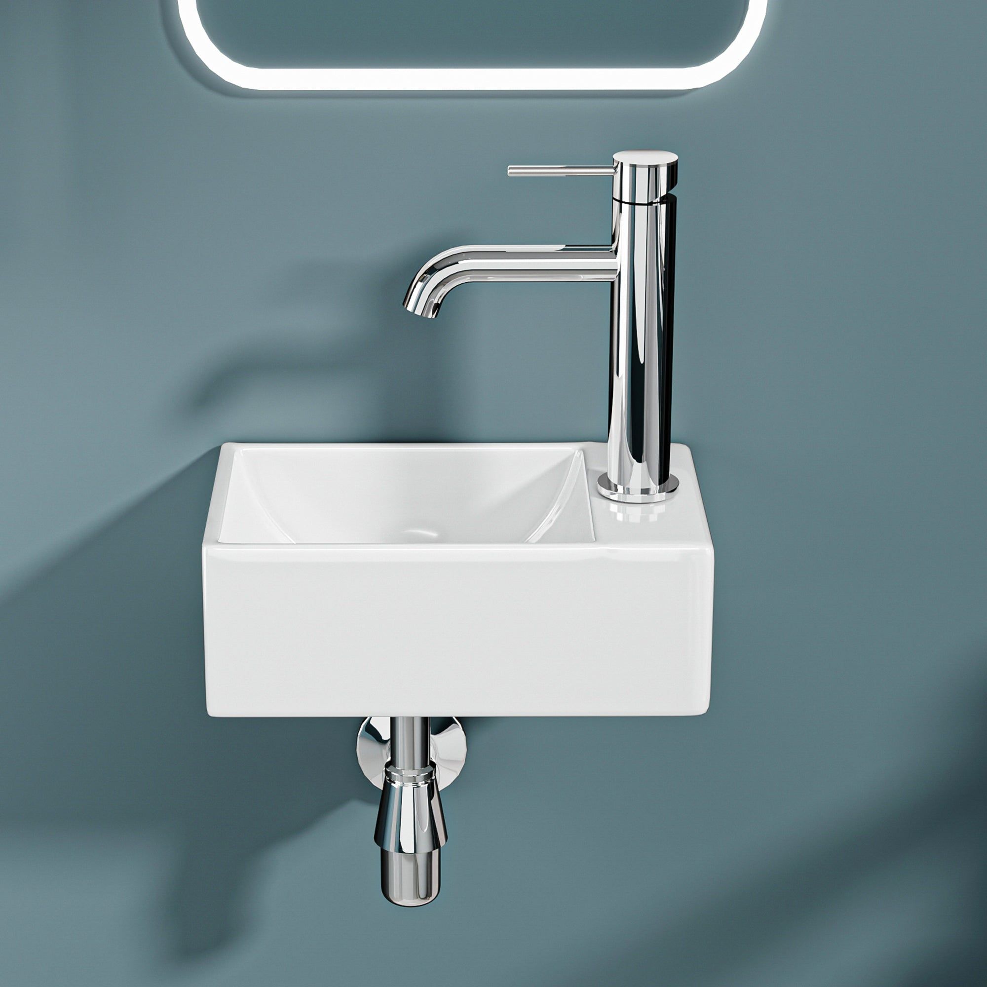 Mini lavabo mural : Lavabo compact en céramique blanche avec robinet chromé, idéal pour les petites salles de bain ou salles d'eau.