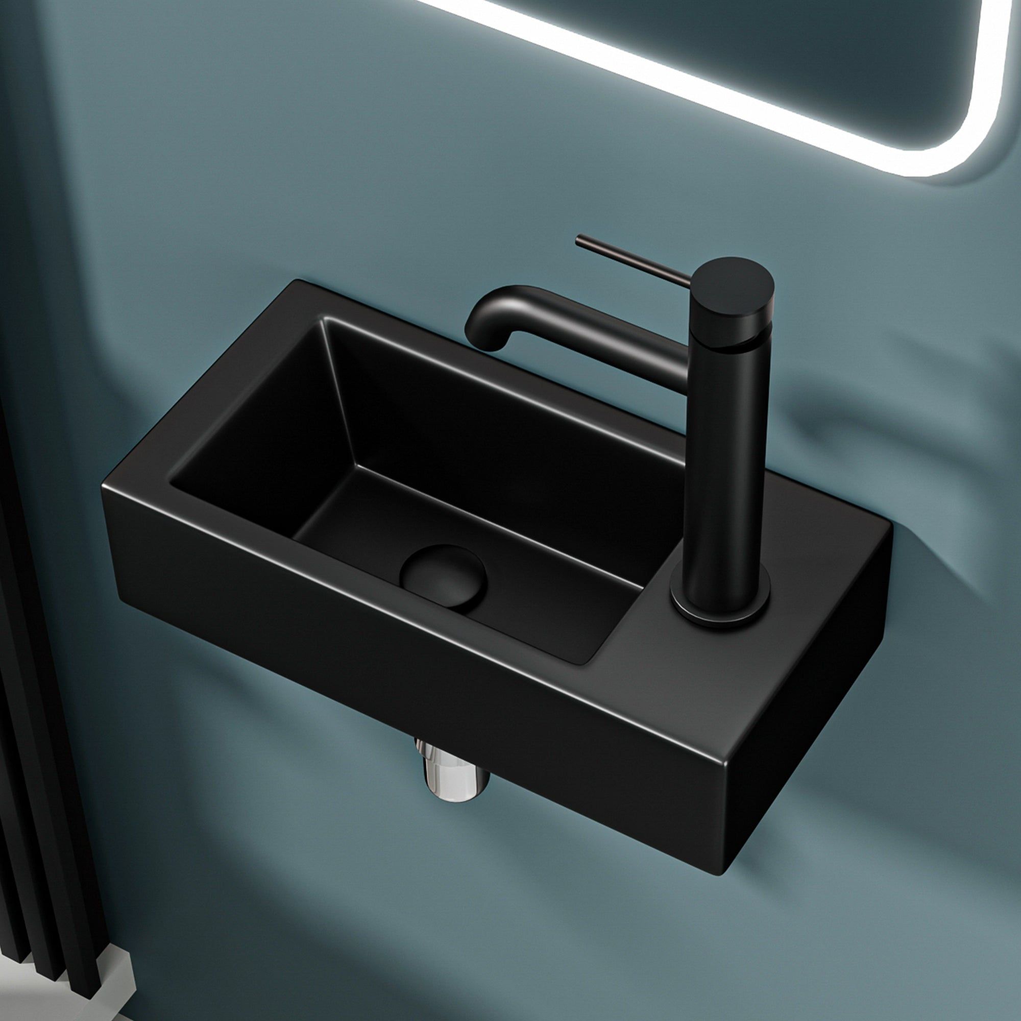 Lavabo mural noir mat avec bonde à gauche et robinet moderne
