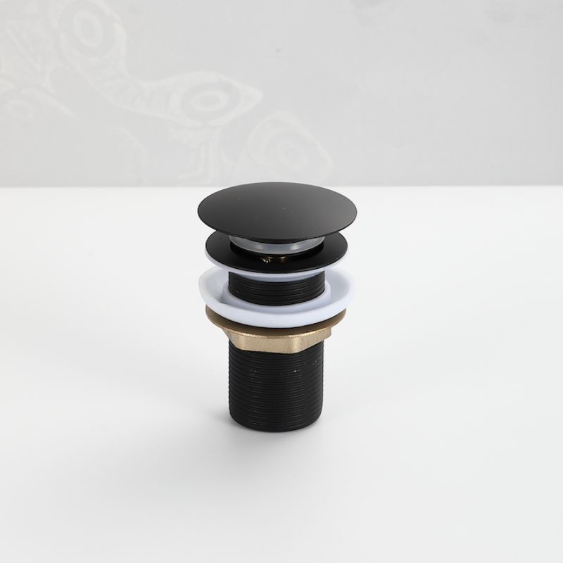 Bonde Pop-Up noir mate : Bouchon de bonde de lavabo à poussoir au fini noir mat avec des accents en laiton et blancs.