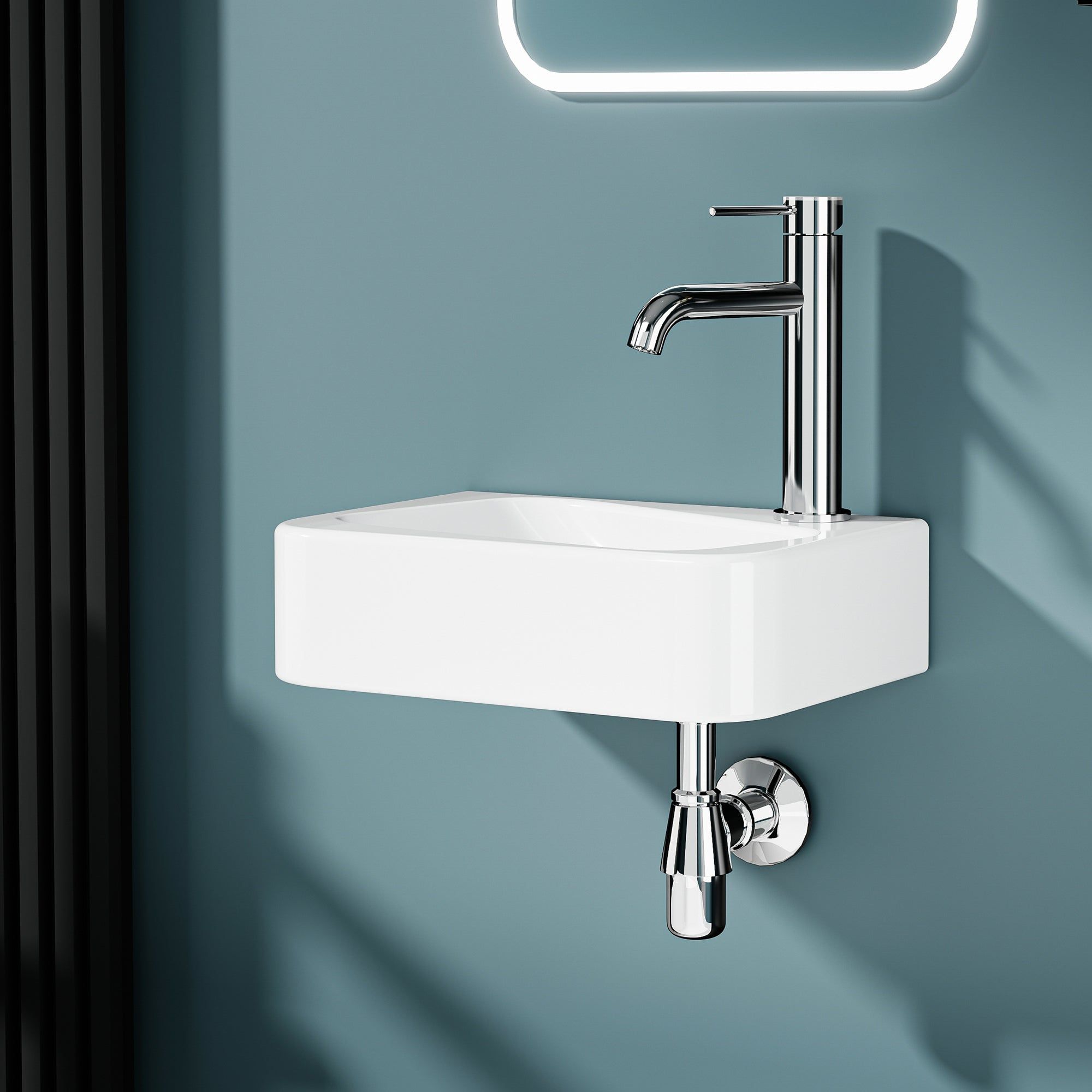 Lave-mains murale asymmétrique en céramique blanche avec robinet chromé, sortie droite.