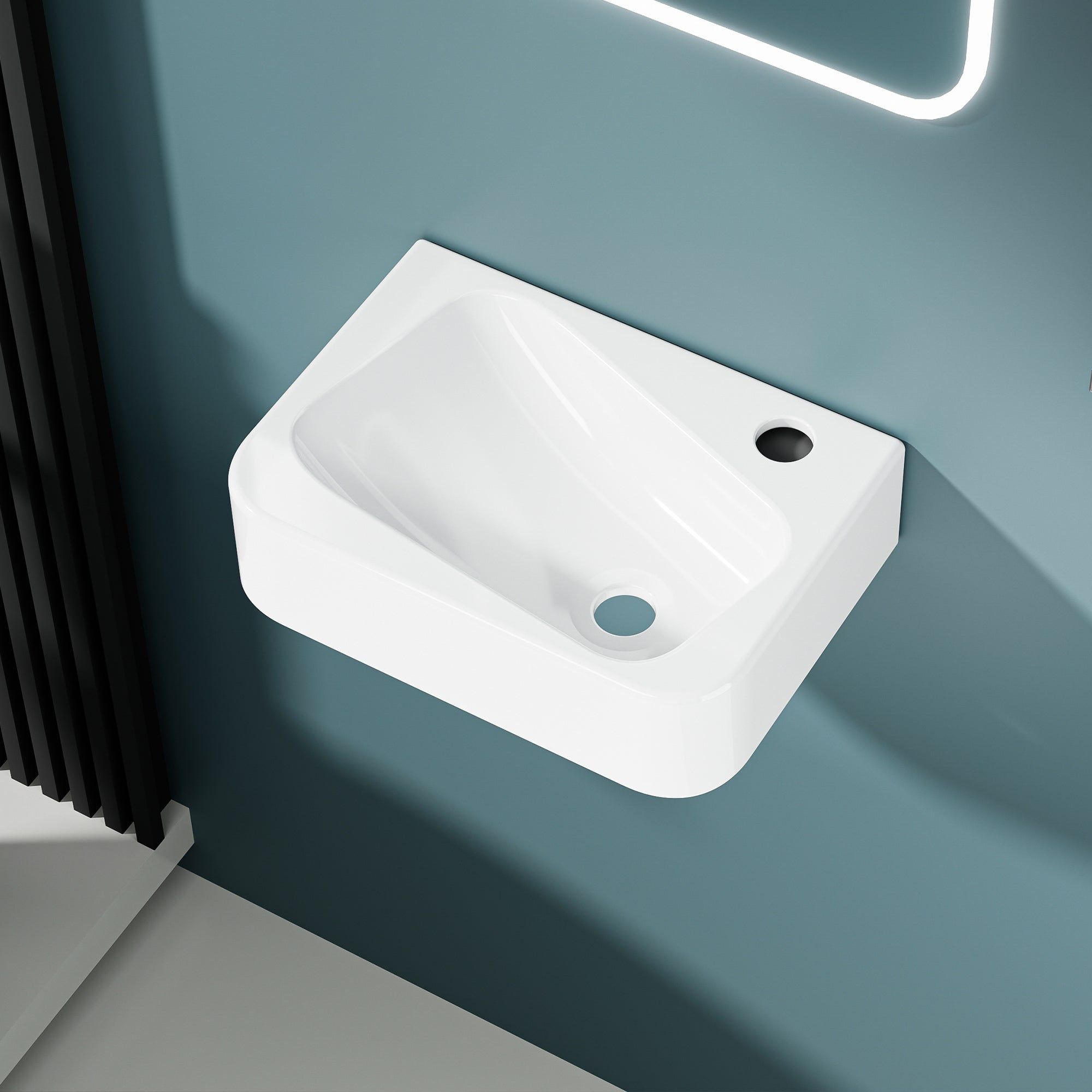 Lavabo mural blanc en céramique avec sortie d'eau droite, modèle asymmétrique.